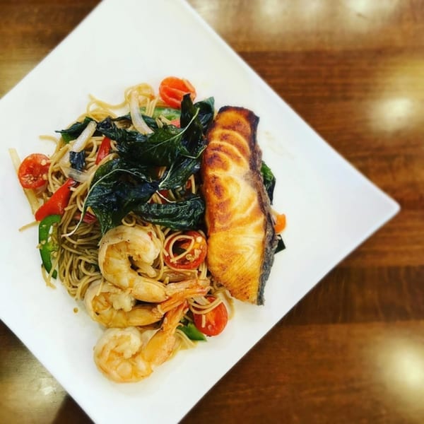 Akeno Sushi Bar and Thai's pan-fried salmon and shrimp with noodles, vegetables, and basil.