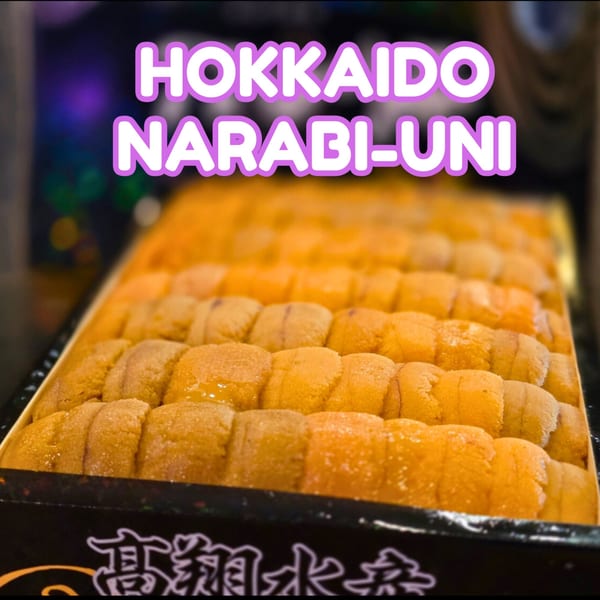 A box filled with rows of bright orange Hokkaido Narabi-Uni (sea urchin roe).