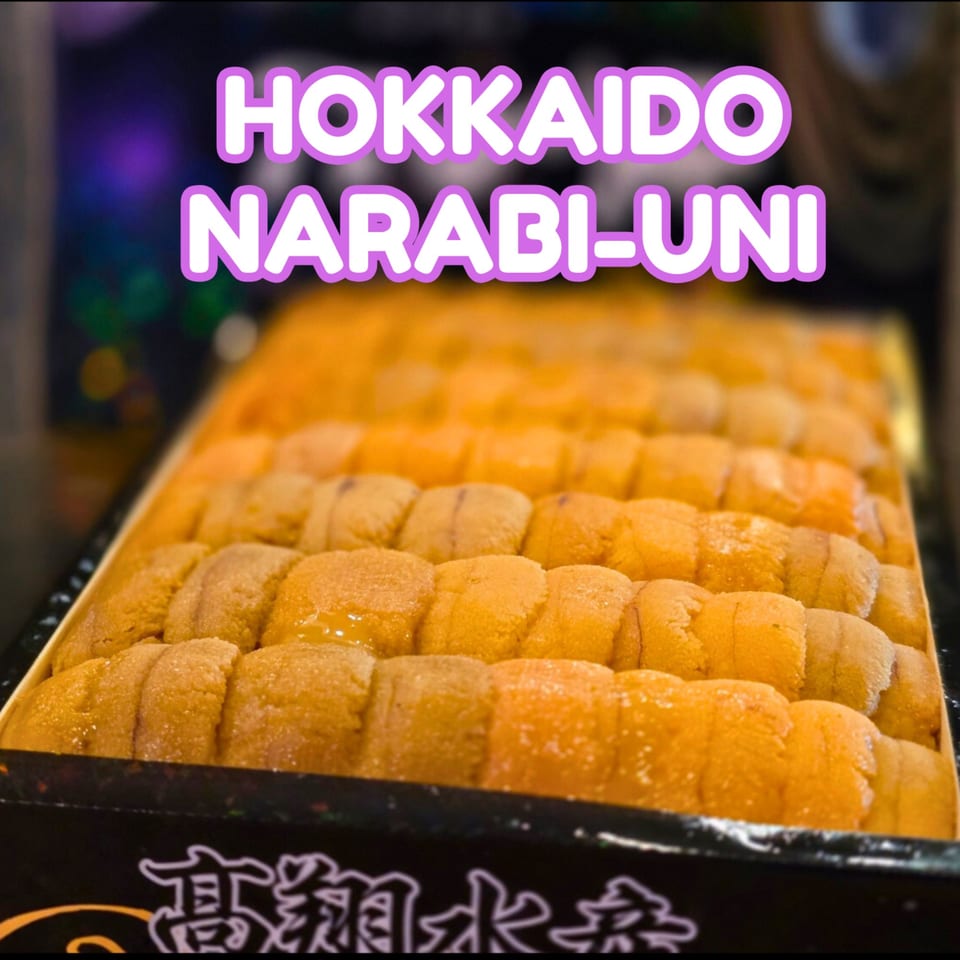 A box filled with rows of bright orange Hokkaido Narabi-Uni (sea urchin roe).